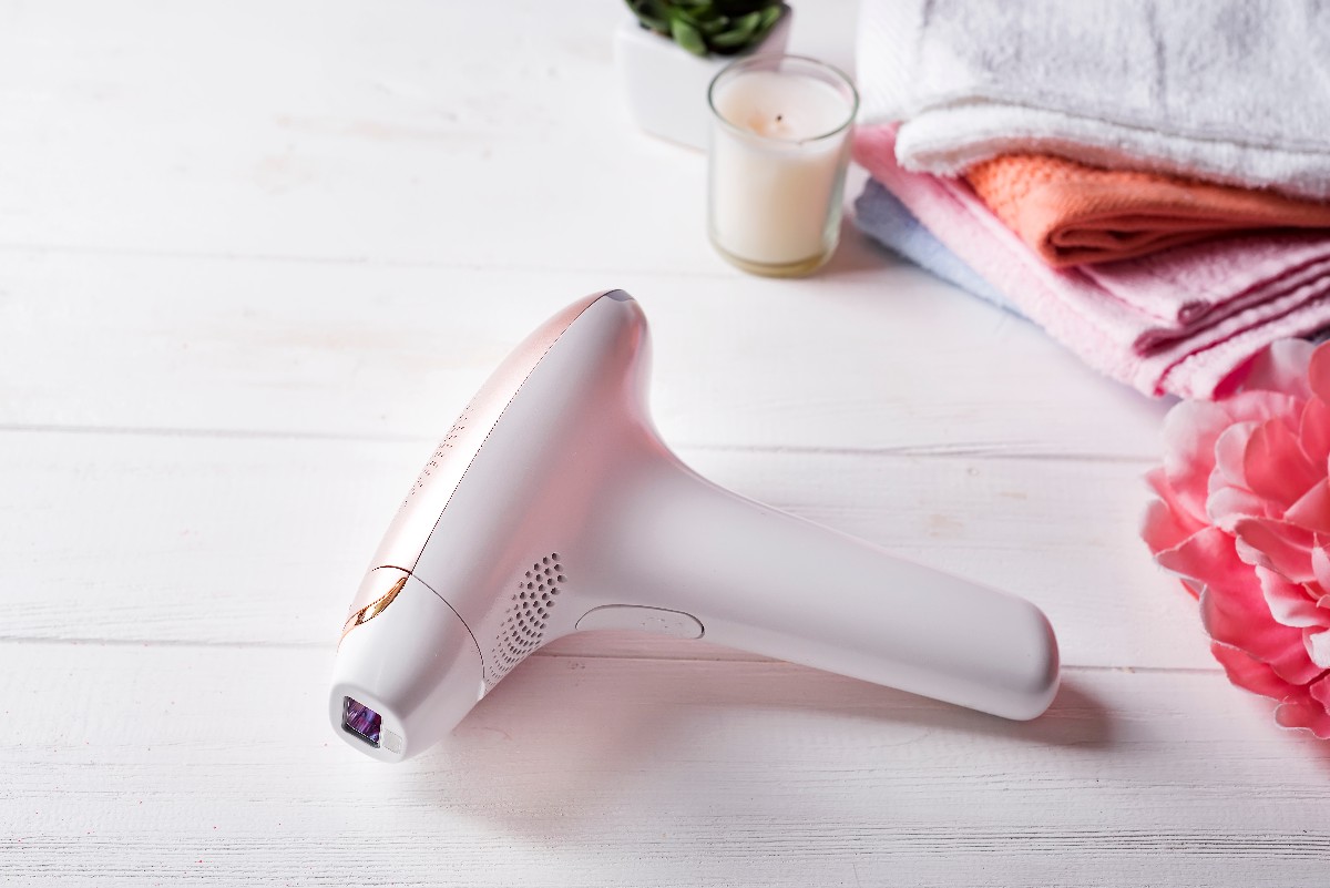 Modern Laser Epilator With Bath Accessories On White Background.